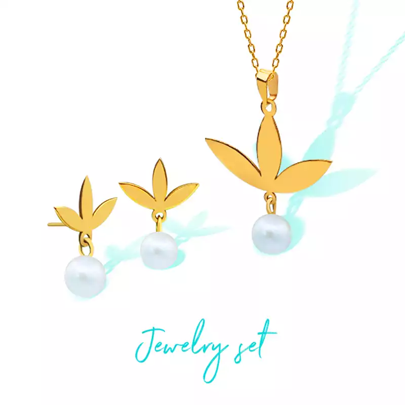 Gold semi-set with a leaf and pearl design, including a necklace and earrings.
